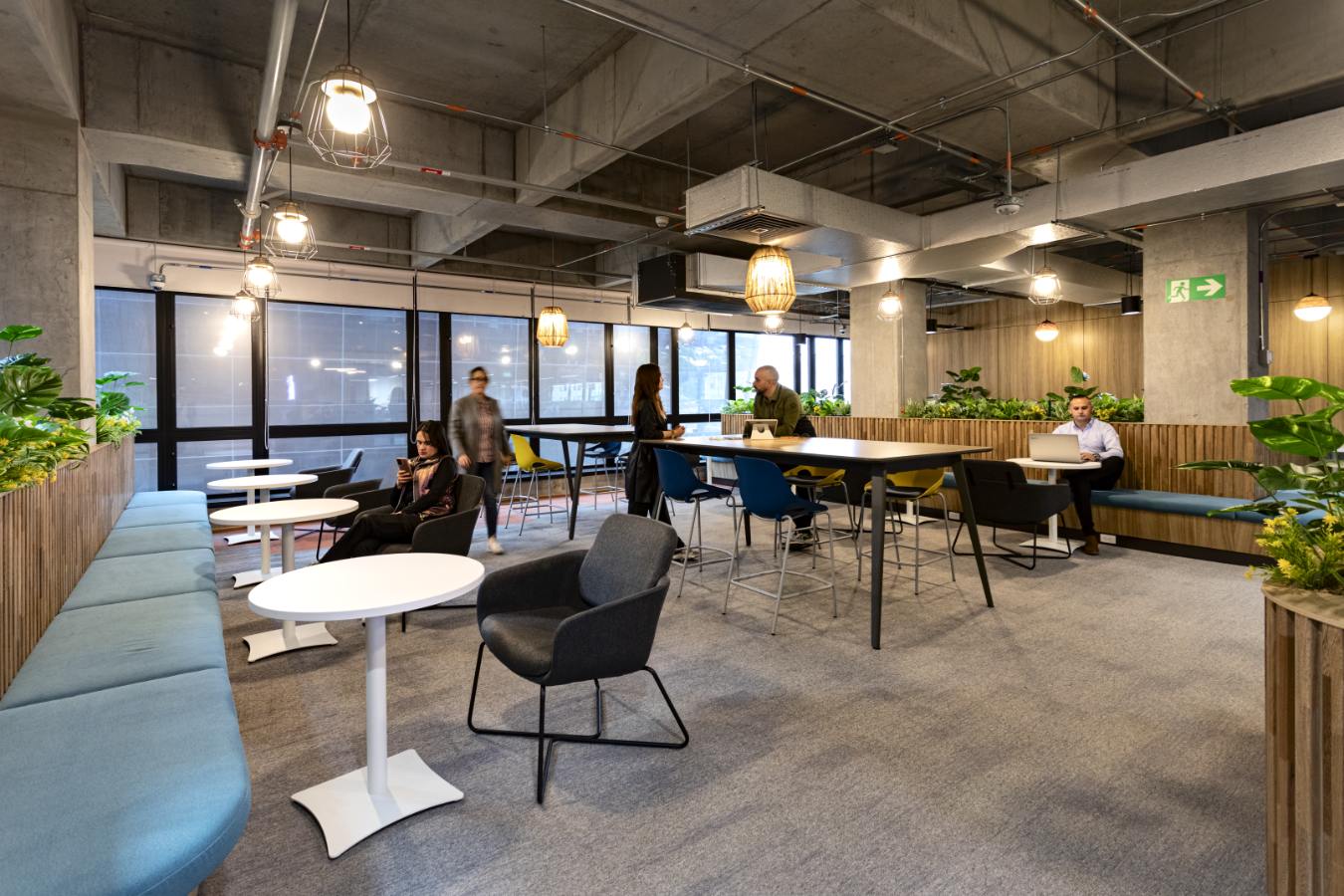 Emapta Offices - Flexible breakout zone near windows with varied seating options - Contract Workplaces.jpg